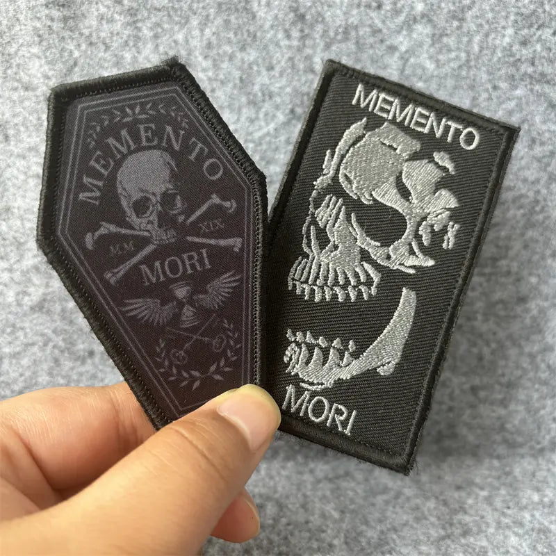 Memento Mori patch held in hand