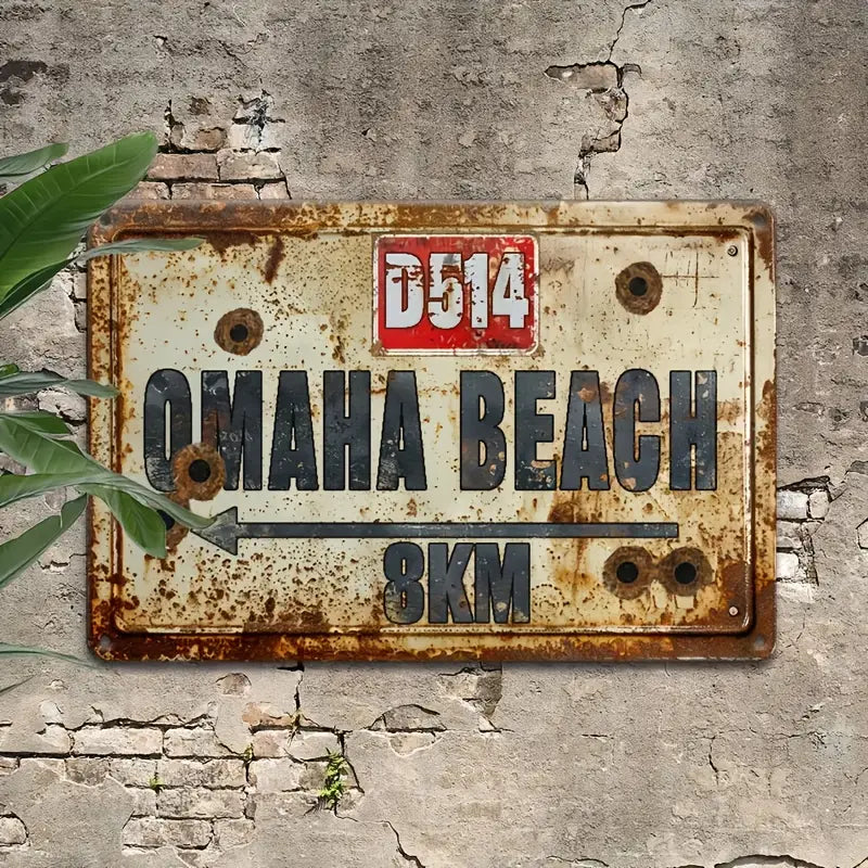 Rusted metal wall sign reading Omaha Beach 8KM with route marker D514