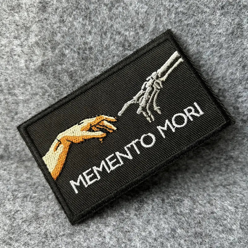 Memento Mori embroidered morale patch, black with skeletal hand, 9.5x5.5 cm