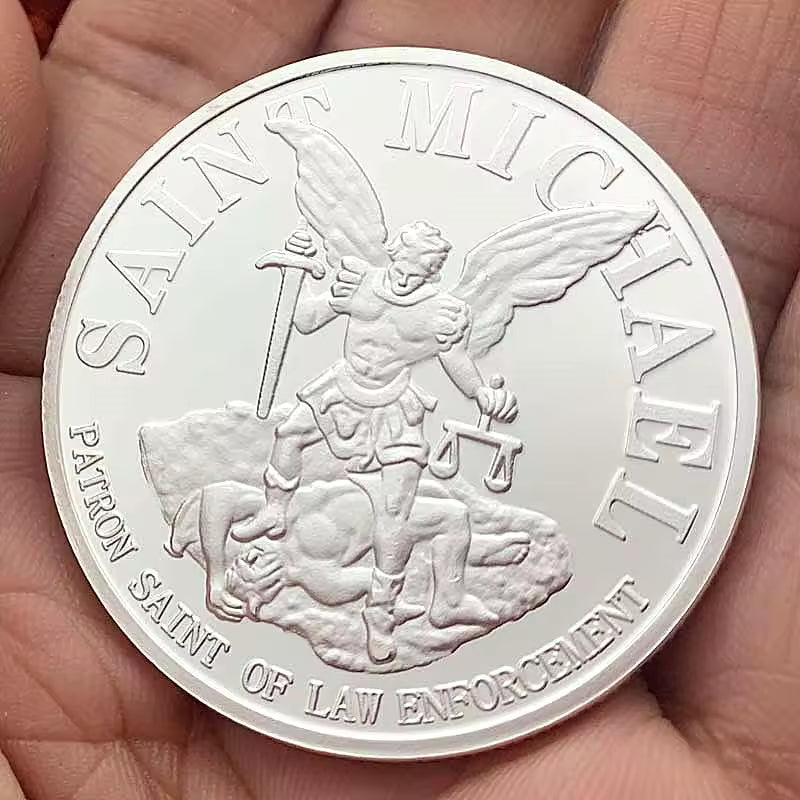 Saint Michael challenge coin, silver, held in hand